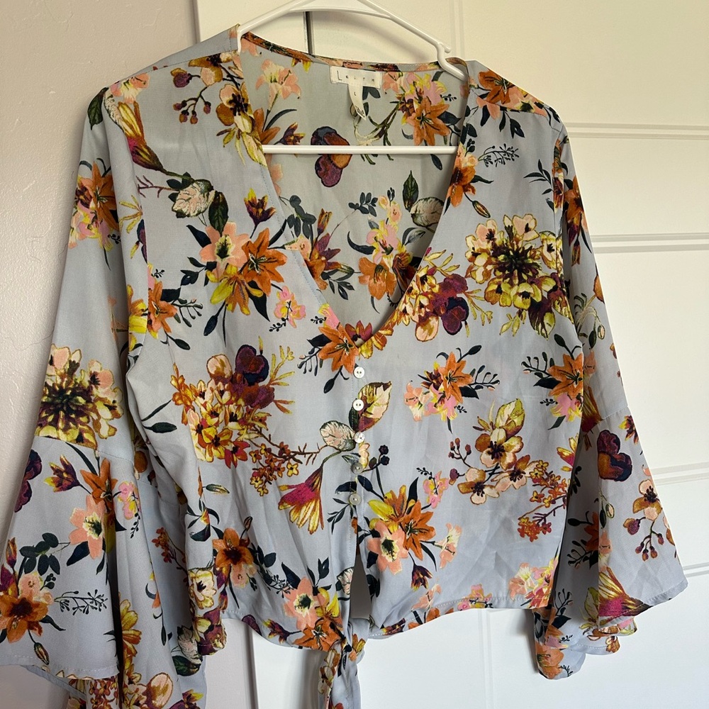 Blue floral top with tie and pearl button detail